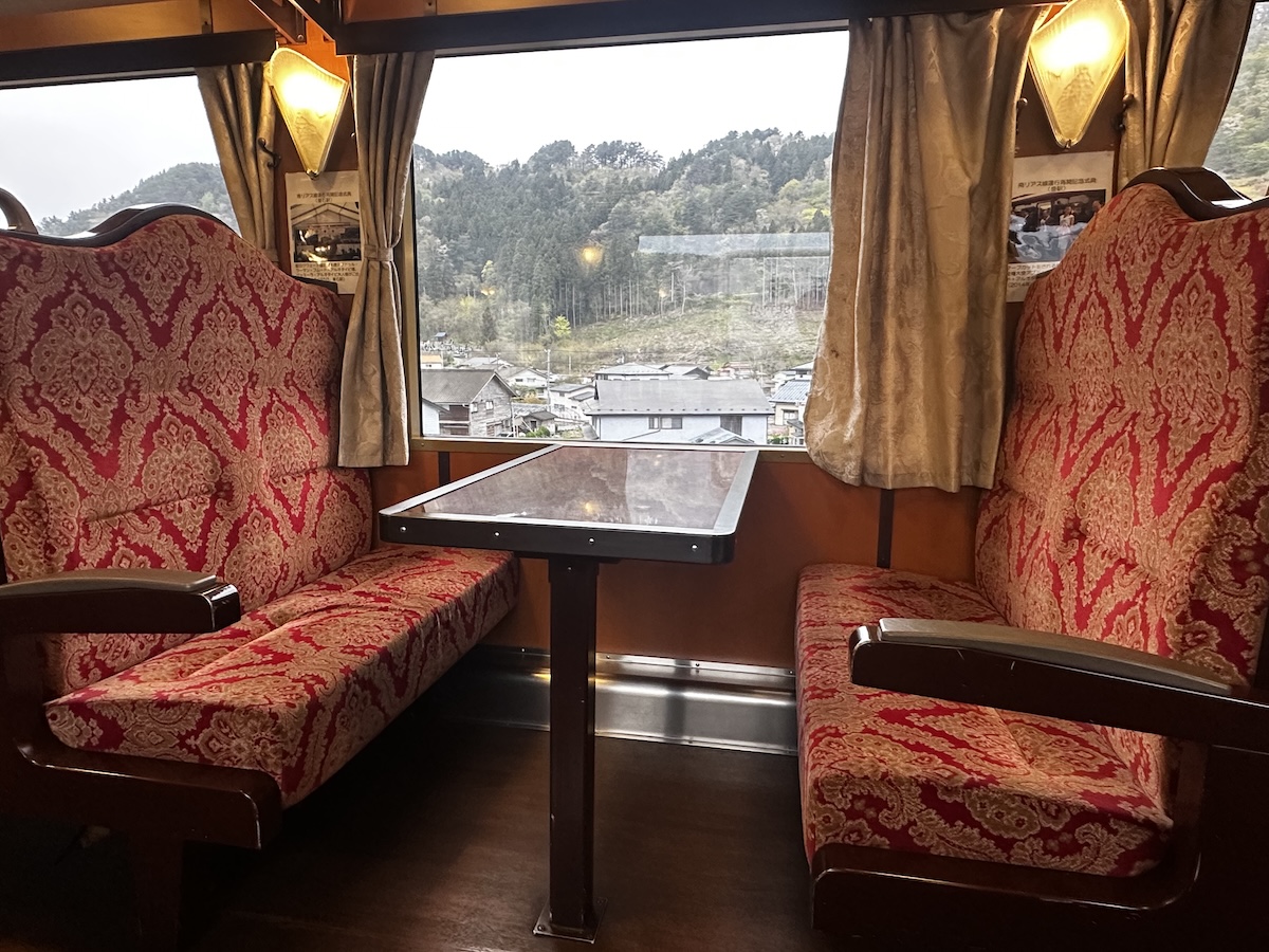 Train interior with red patterned seats